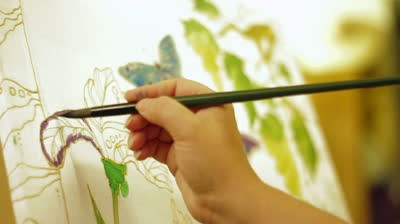 stock-footage-person-painting-an-image-using-batik-technique-wax-printing